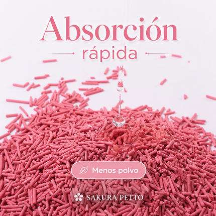 Gotas de agua cayendo y siendo absorbidas inmediatamente por un montón de arena de tofu para gatos SAKURA PETTO de color rosa.